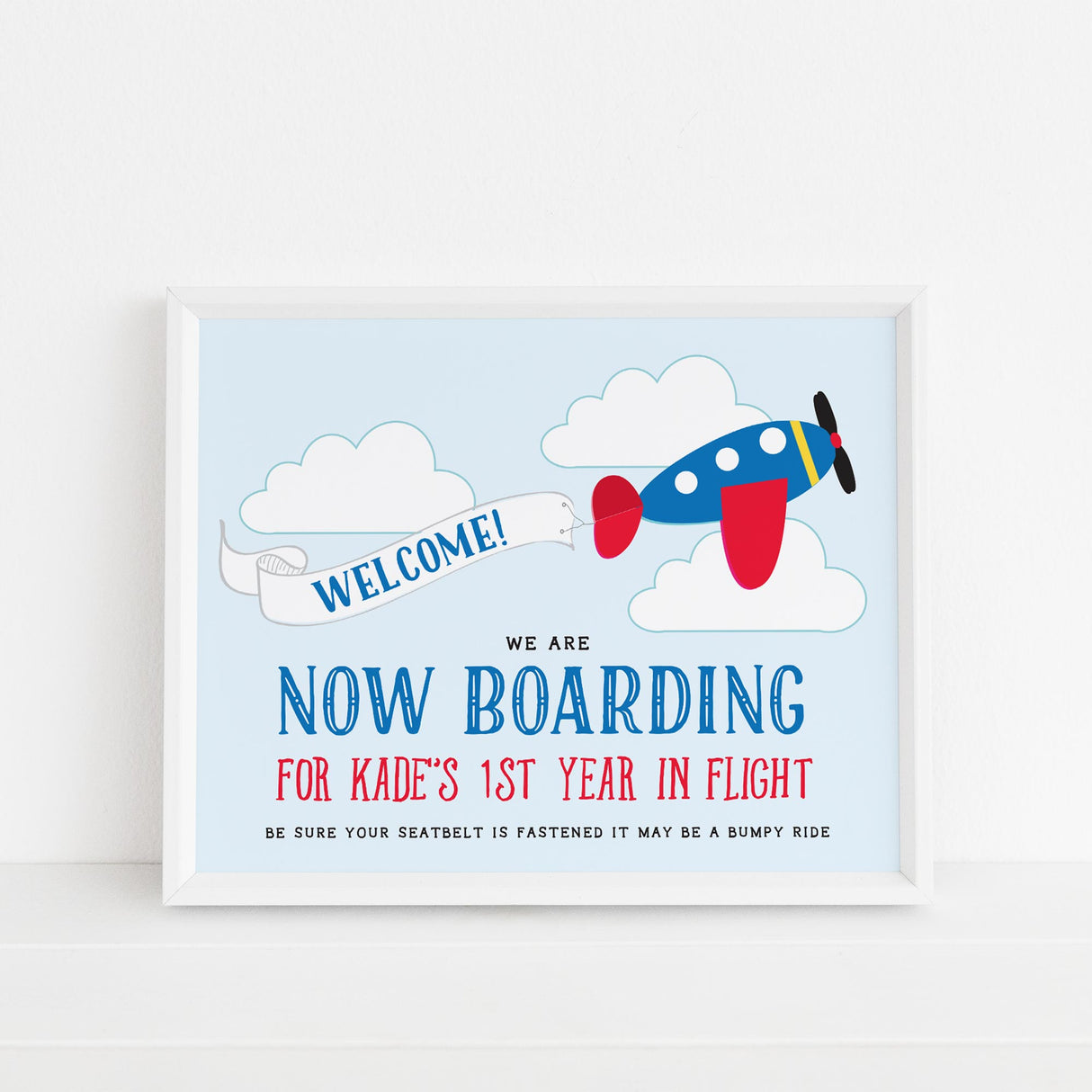 welcome sign with blue and red airplane design and now boarding text printed on white cardstock