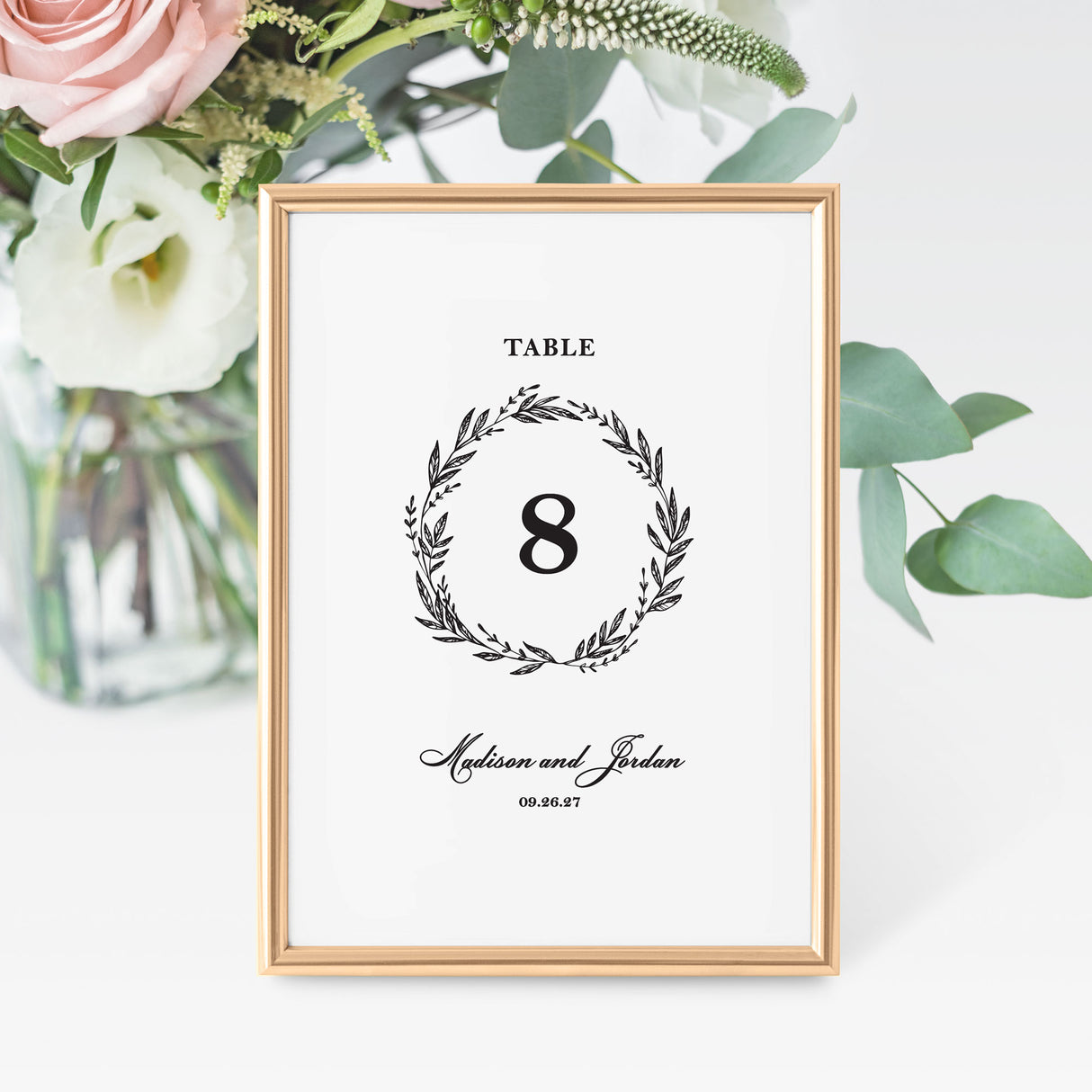 classic black and white wedding table number card with a wreath design