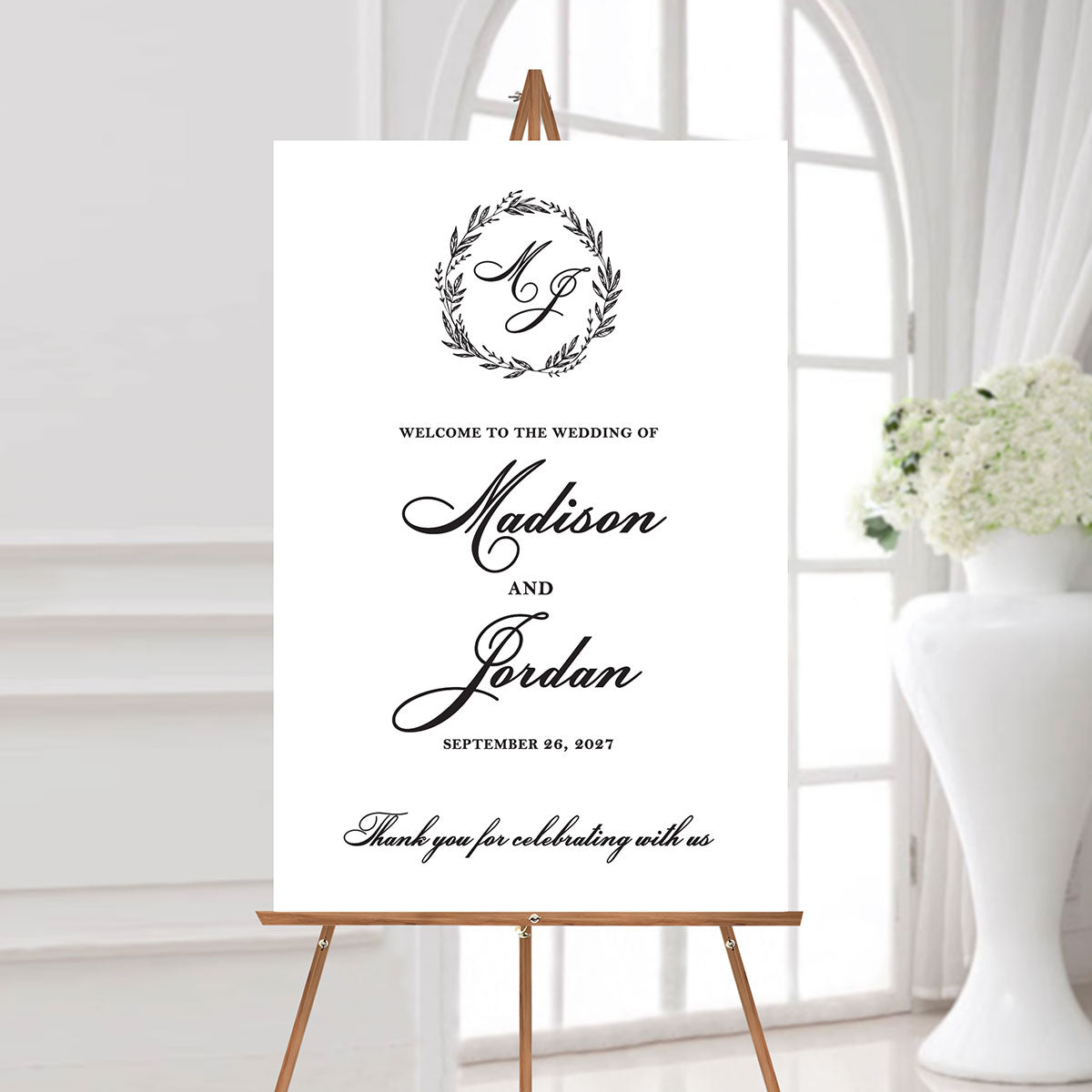wedding welcome sign with a classic monogrammed wreath design featuring the couple's names and wedding date