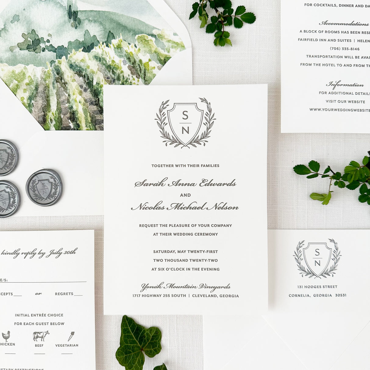 classic laurel crest wedding invitation with traditional script and block fonts printed on white cardstock