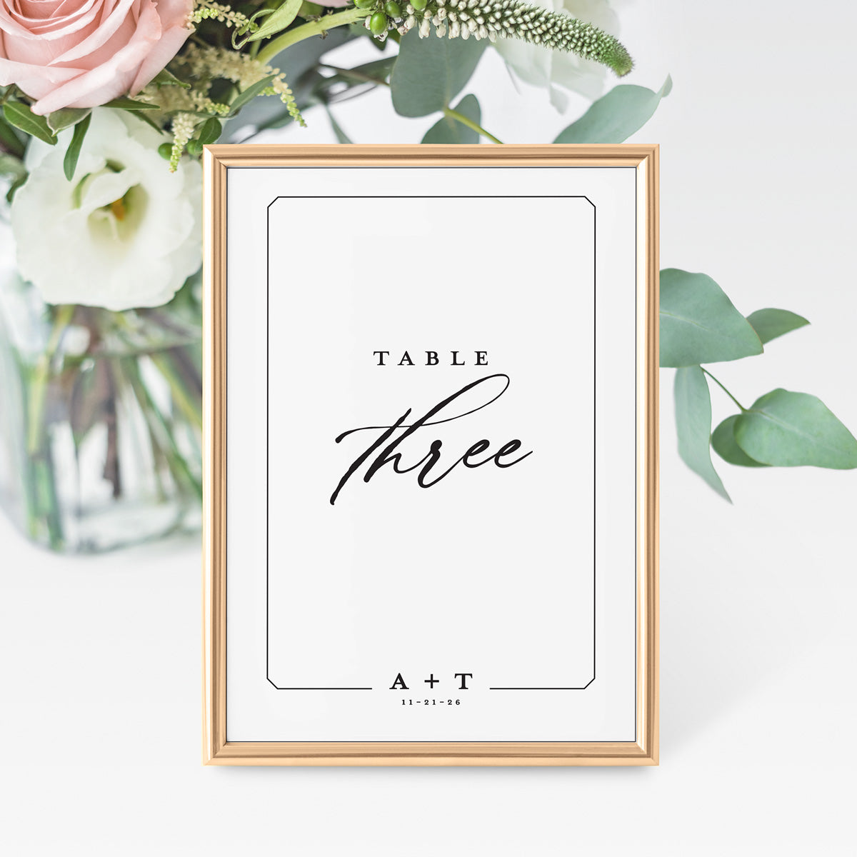 modern black and white wedding table number displaying the text in elegant script