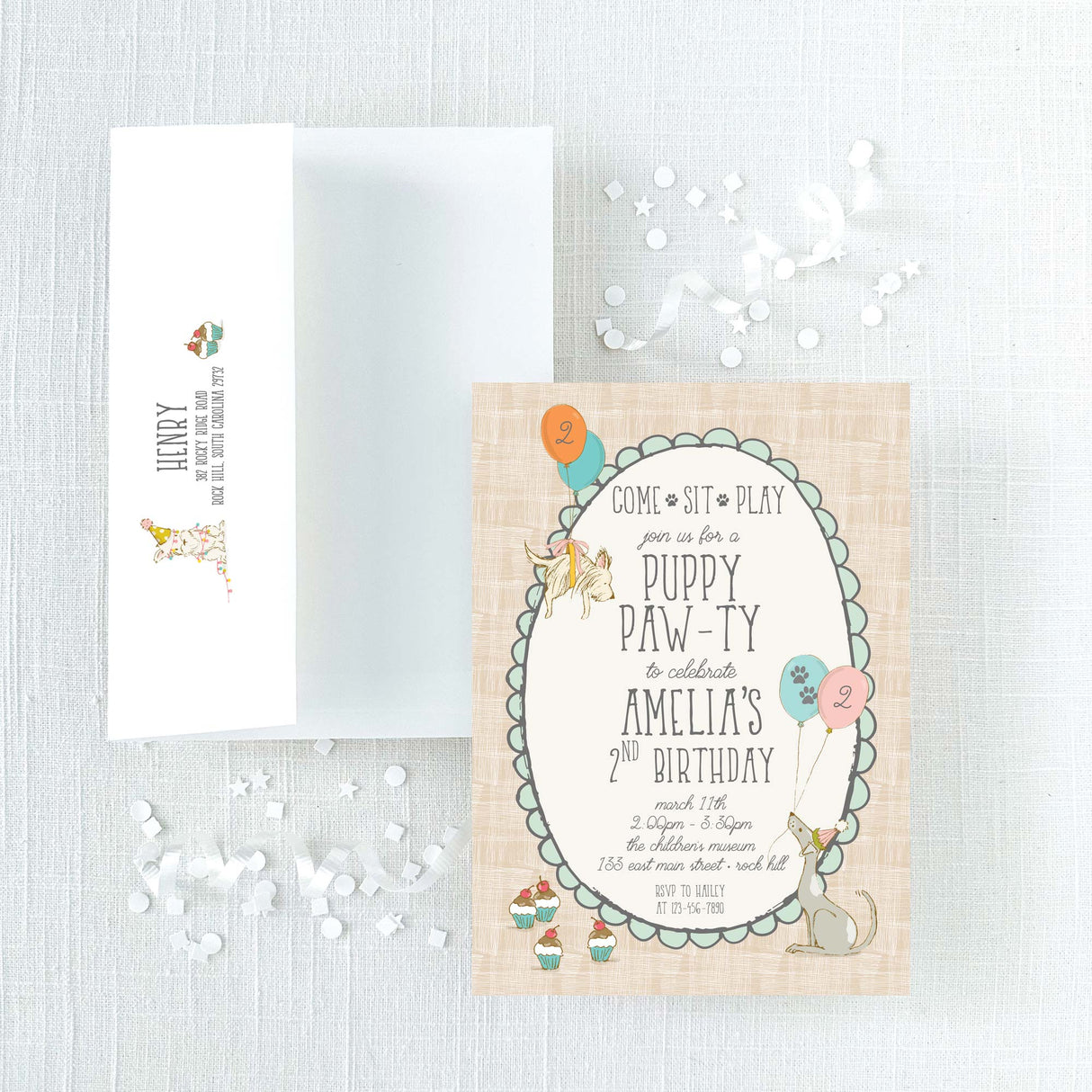 invitation and envelope for a puppy-themed birthday party with illustrations of puppies, balloons, and cupcakes