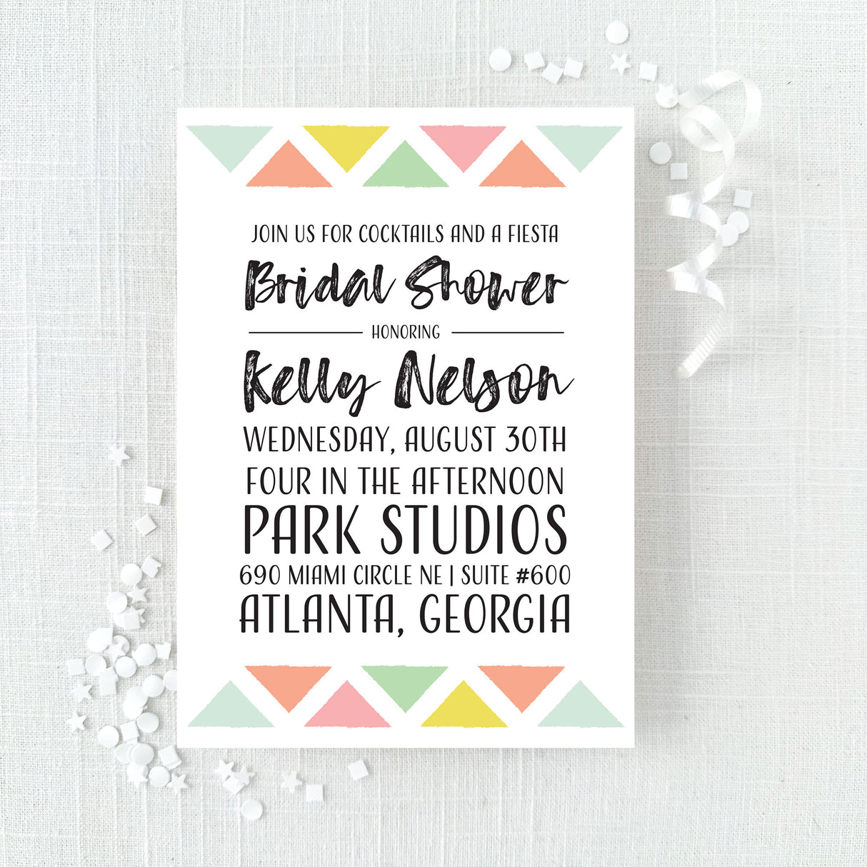 Bridal shower invitation with colorful geometric design printed on white cardstock