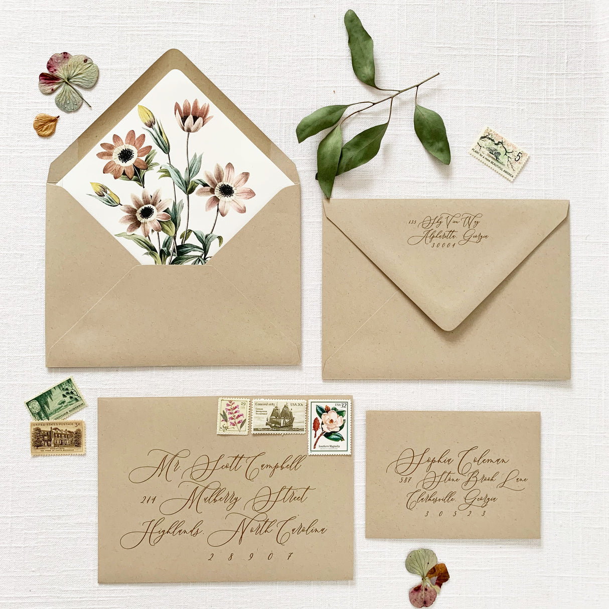 tan envelopes with floral envelope liner and addressing in brown ink