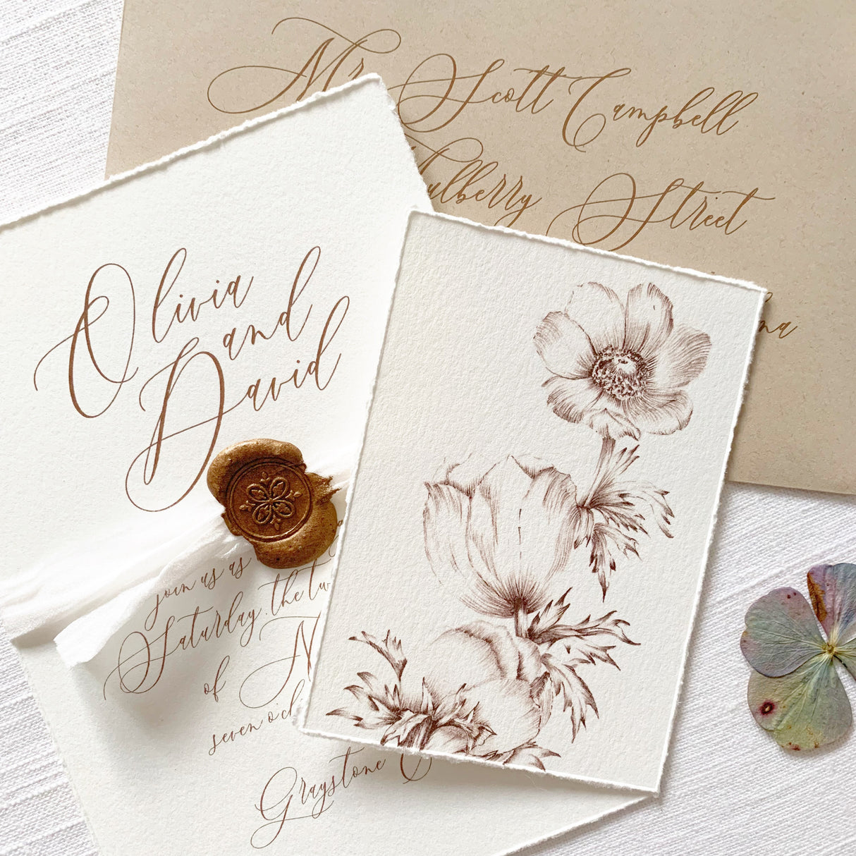 cream and brown invitation cards with hand torn edges