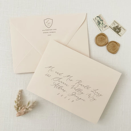 pale blush envelopes with guest and return addressing in gray ink