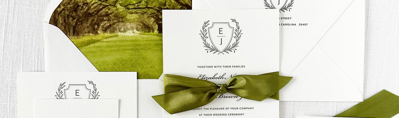 Green and white wedding invitation set with ribbon on a white background
