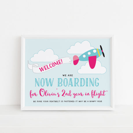 birthday welcome sign with pink and turquoise airplane design