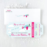 Pink and turquoise Airplane-themed birthday invitations that look like plane tickets and white envelope with return addessing