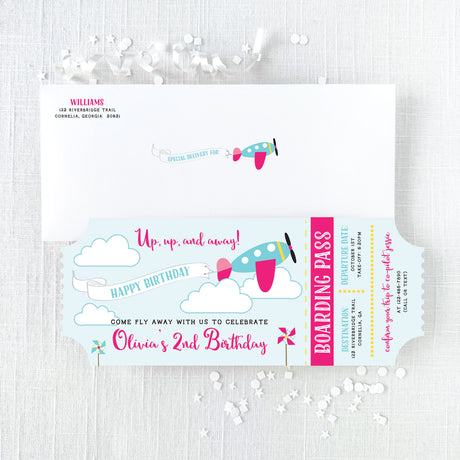 Pink and turquoise Airplane-themed birthday invitations that look like plane tickets and white envelope with return addessing
