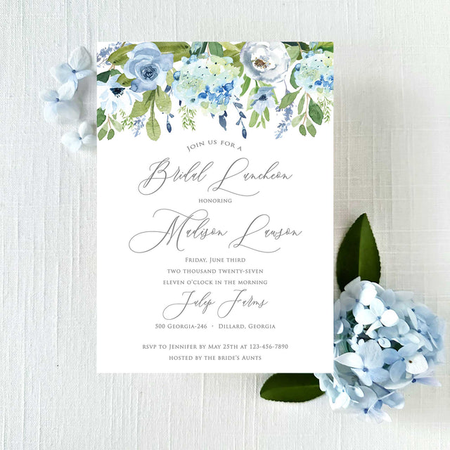 bridal luncheon invitation with shades of blue florals and greenery and elegant script font printed on white cardstock