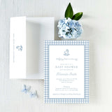 Baby shower invitation with blue checkered border and white envelope with return addressing