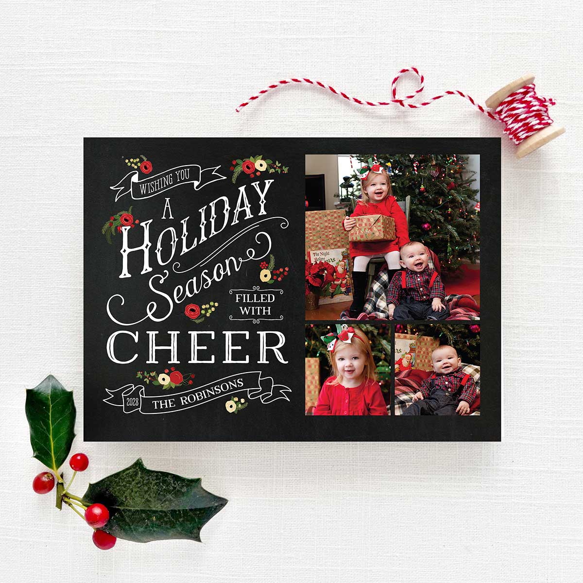 Chalkboard Christmas holiday card featuring personalized photos with a black chalkboard background, white text, vintage banners and holiday florals