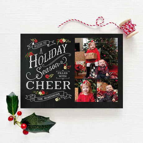 Chalkboard Christmas holiday card featuring personalized photos with a black chalkboard background, white text, vintage banners and holiday florals