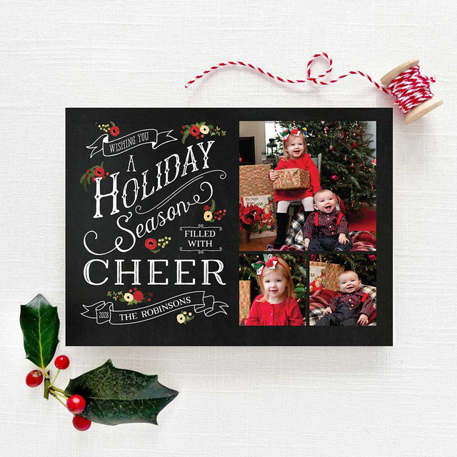 Chalkboard Christmas holiday card featuring personalized photos with a black chalkboard background, white text, vintage banners and holiday florals