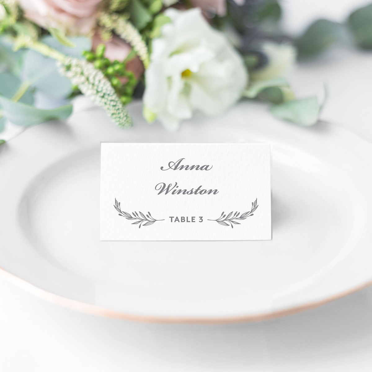 white and gray folded place card with classic laurel accents and traditional script and block fonts printed on white cardstock