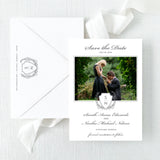 classic wedding save the date card with grey monogram crest and photo of couple with white envelope printed with return address