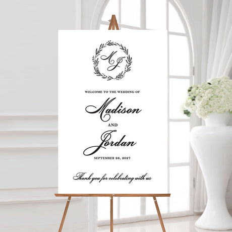 wedding welcome sign with a classic monogrammed wreath design featuring the couple's names and wedding date
