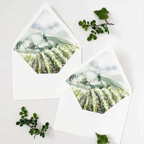 white wedding envelopes with watercolor vineyard design on envelope liner