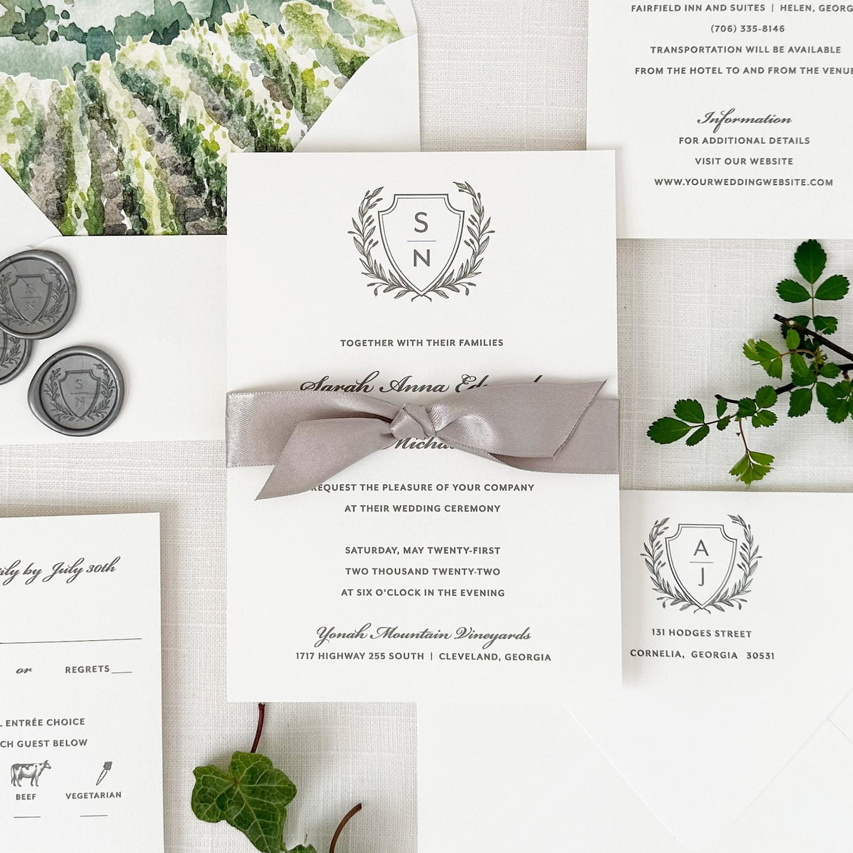 classic laurel crest wedding invitation with traditional script and block fonts in gray printed on white cardstock with gray satin ribbon 