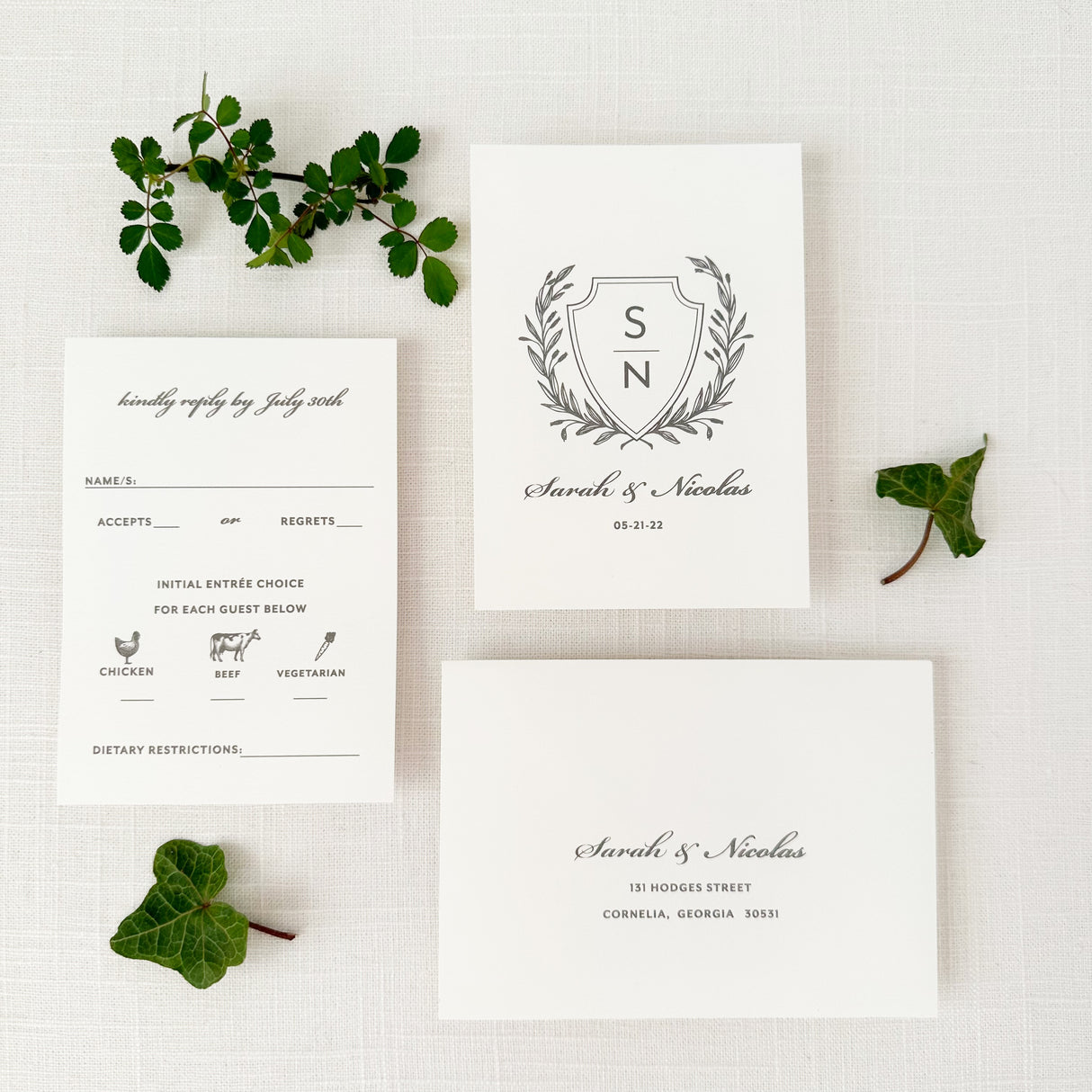 gray rsvp card and envelope with laurel crest design printed on white cardstock