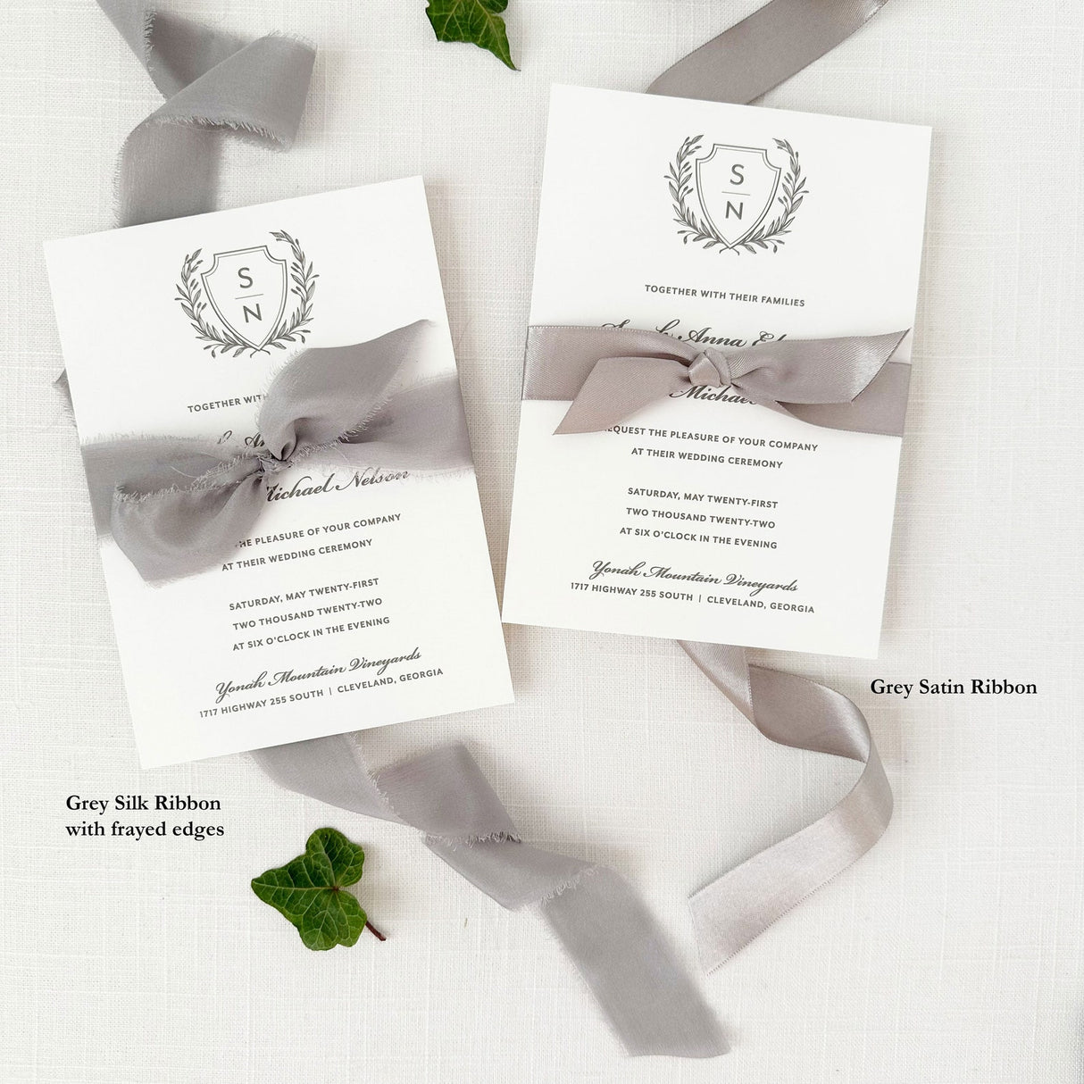 traditional wedding invitation with gray crest showing examples of satin and silk ribbon 