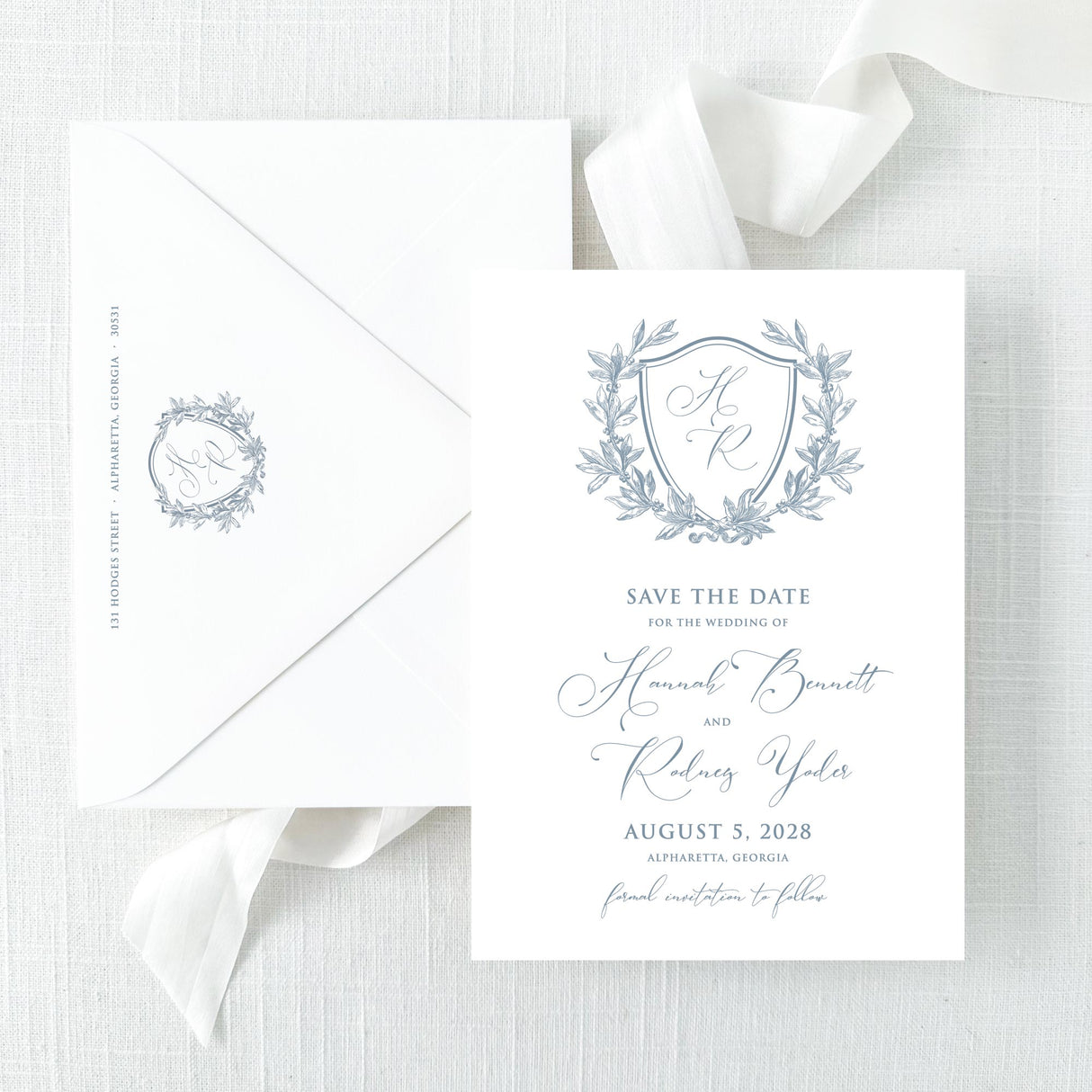 save the date with dusty blue monogram and script font and envelope with return addressing