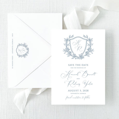 save the date with dusty blue monogram and script font and envelope with return addressing