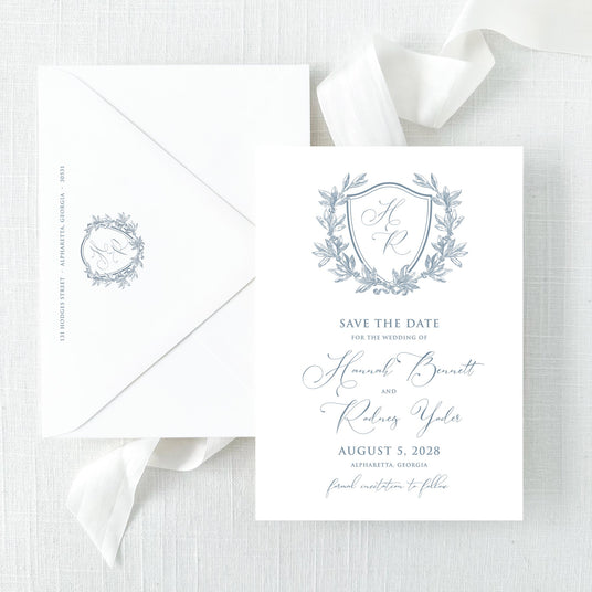 save the date with dusty blue monogram and script font and envelope with return addressing