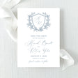 dusty blue wedding save the date card with floral wreath monogram design with calligraphy font