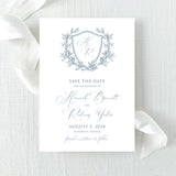 dusty blue wedding save the date card with floral wreath monogram design with calligraphy font