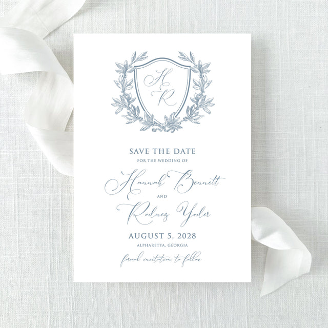 dusty blue wedding save the date card with floral wreath monogram design with calligraphy font