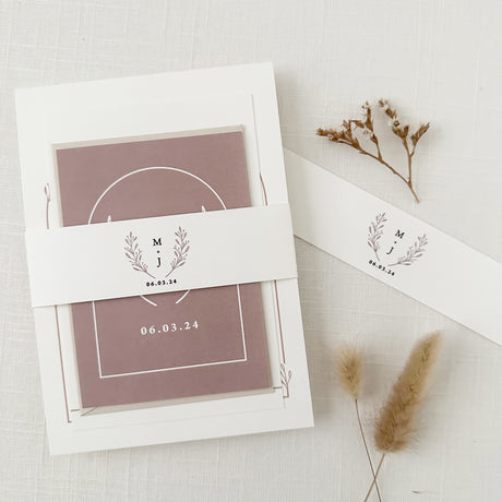 dusty rose invitation set wrapped with a monogrammed belly band featuring dusty rose monogram