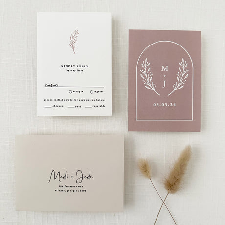 rsvp card with modern script font and  dusty rose monogram on the back side of the card with taupe envelope and addressing