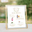 Bar menu with gold monogrammed crest and watercolor pictures of drinks