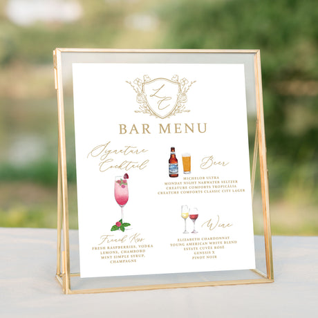 Bar menu with gold monogrammed crest and watercolor pictures of drinks
