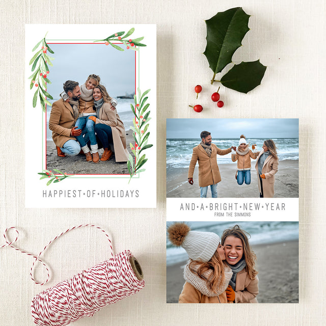custom holiday photo card with greenery and red berry frames and modern block fonts in gray ink printed on white cardstock
