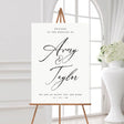 black and white modern and minimal wedding welcome sign with couple's name in a hand written script font