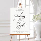 black and white modern and minimal wedding welcome sign with couple's name in a hand written script font