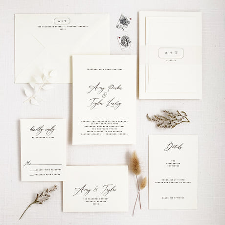 modern and minimal wedding invitation set in black and white with calligraphy script and block fonts