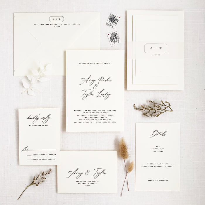 modern and minimal wedding invitation set in black and white with calligraphy script and block fonts