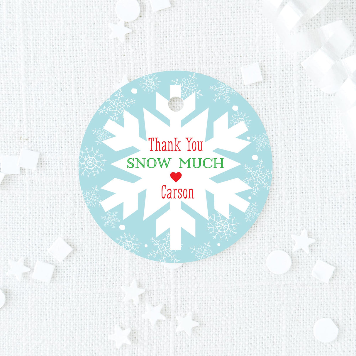 blue, red, and green favor tag with snowflake design on a blue background printed on white cardstock
