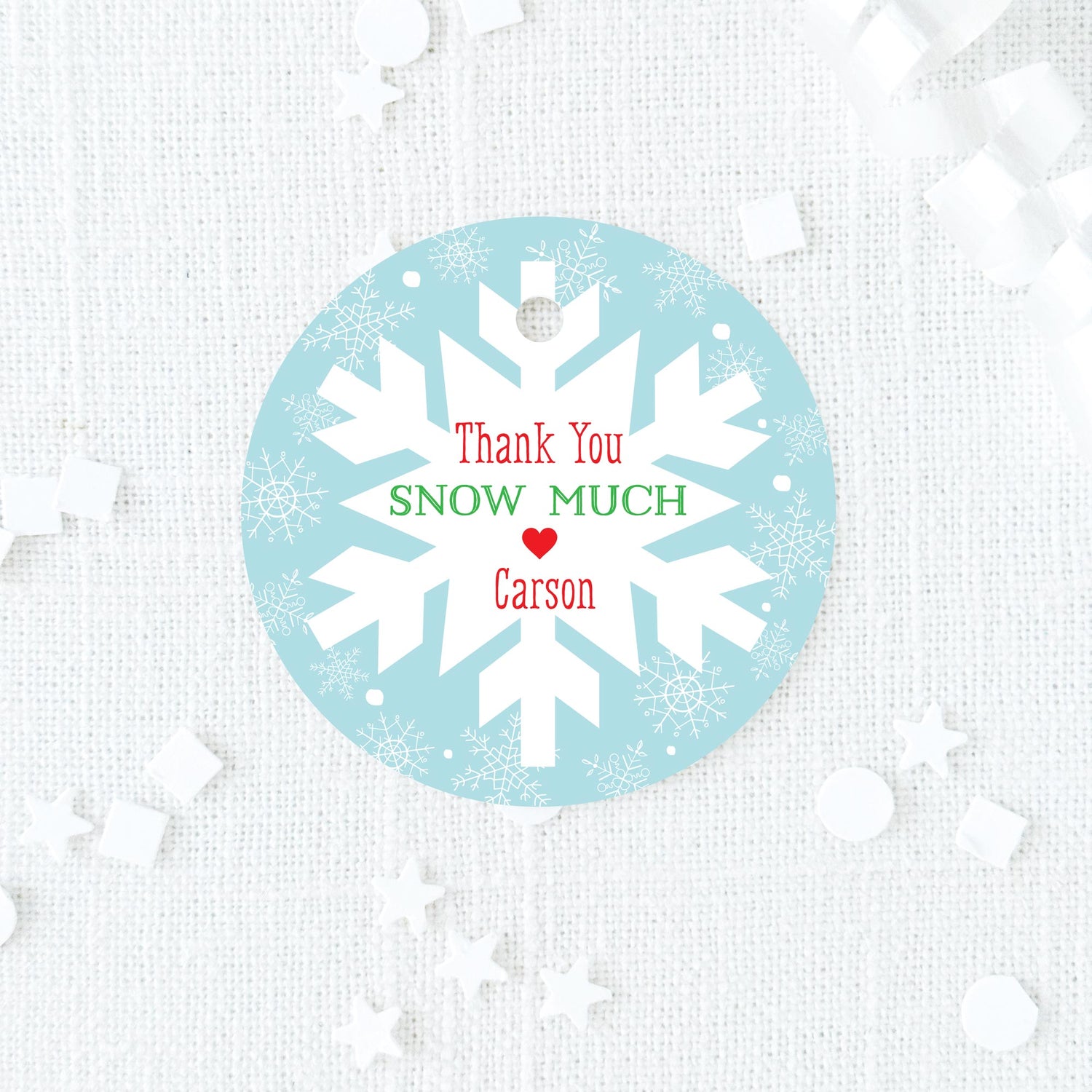 blue, red, and green favor tag with snowflake design on a blue background printed on white cardstock
