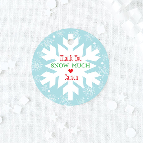 blue, red, and green favor tag with snowflake design on a blue background
