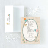 invitation and envelope for a puppy-themed birthday party with illustrations of puppies, balloons, and cupcakes 