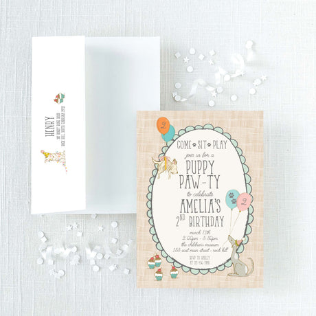 invitation and envelope for a puppy-themed birthday party with illustrations of puppies, balloons, and cupcakes 