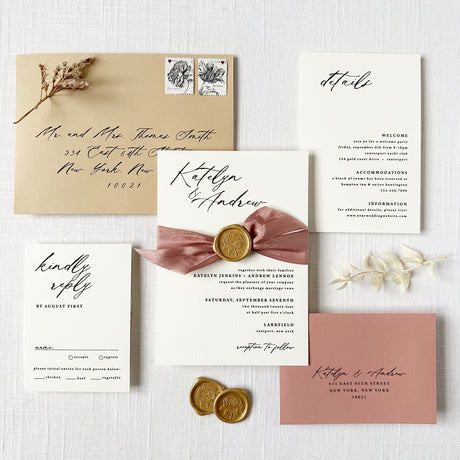 wedding invitation with dusty rose ribbon and gold wax seal featuring calligraphy fonts and tan and dusty rose envelopes