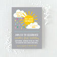 Birthday invitation with yellow sun and clouds with colorful rain design printed on white cardstock
