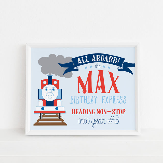 Children's birthday sign with a red and blue train design and text on a light blue background