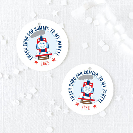 blue and red round party favor tag with train design